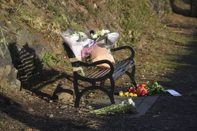 Floral tributes have been left on a bench close to where Ms O'Neill was found. Picture: Greg Macvean