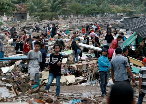 Rescuers and residents look for survivors along the coast in South Lampung on South Sumatra on December 23, 2018. Picture: Getty Images
