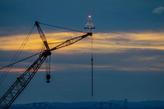 Festive Christmas Tree on top of a crane at Briggs Marine in Burntisland, Fife. Picture: SWNS