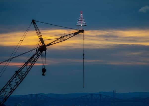 Festive Christmas Tree on top of a crane at  Briggs Marine in Burntisland, Fife. Picture: SWNS