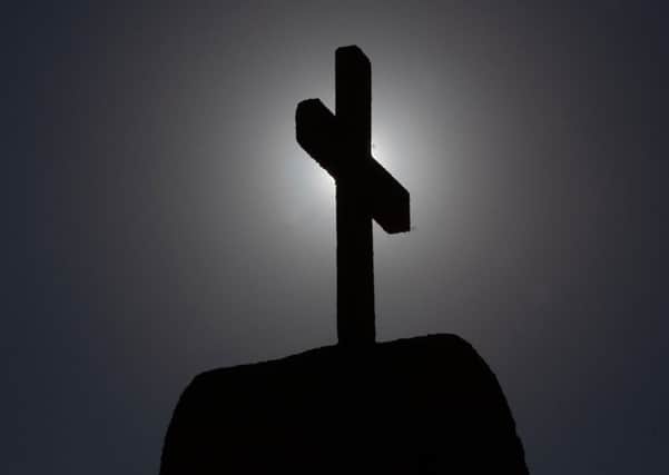 Picture of a cross taken in Punta de Tralca, west of Santiago, on July 30, 2018 as Chile's Episcopal Conference holds an extraordinary meeting to analyze the roots of the current crisis that the Catholic Church is experiencing in the country, burdened by the scandals of sexual abuse and cover-up, and how to overcome it. - Chile is investigating more than 150 members of the country's embattled Catholic Church -- both clergymen and lay people -- for perpetrating or concealing the sexual abuse of children and adults, prosecutors said last week. (Photo by CLAUDIO REYES / AFP)        (Photo credit should read CLAUDIO REYES/AFP/Getty Images)