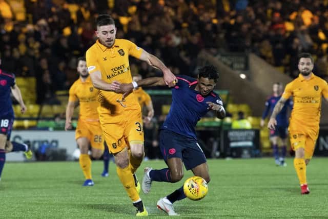 Declan Gallagher of Livingston tussles with Hearts' Demetri Mitchell. Picture: SNS Group