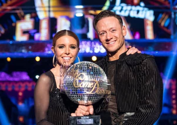 Strictly Come Dancing 2018 winners Kevin Clifton and Stacey Dooley with the glitterball trophy. Picture: PA