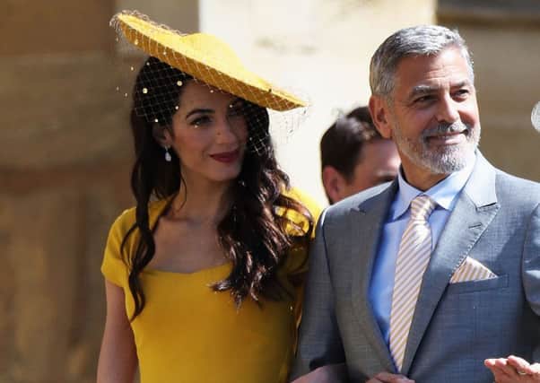 Amal and George Clooney will return to Edinburgh next year. Picture: PA