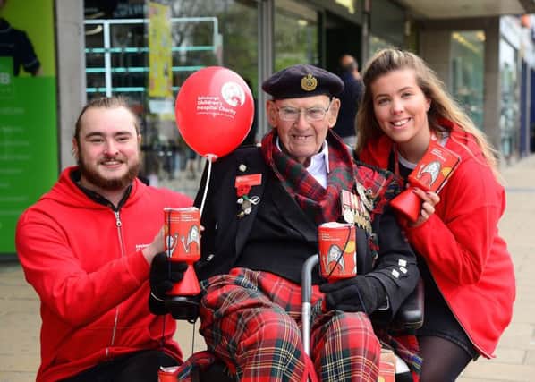 Voracious charity collector Tom Gilzean with Amy Russell and Ollie Snape. Pic: Jon Savage Photography