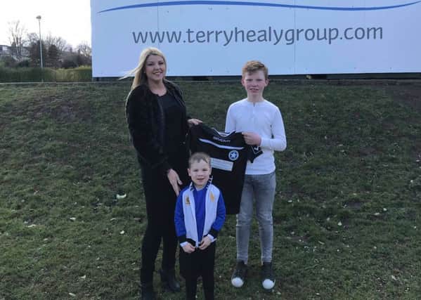 Terry Healy Group sponsor Newtongrange Star Youth Academy, Gayle Anderson, director of Terry Healy Group, Aaron Healy and an academy team captain