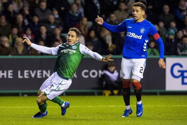 Mark Milligan, left, is one of three Hibs players included in the squad. Picture: SNS