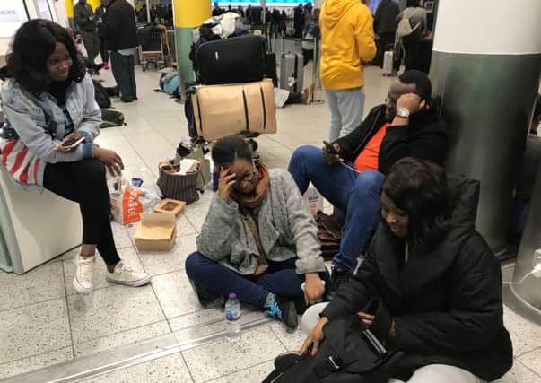 Bride-to-be Tayo Abraham (centre) surrounded friends, part of the wedding party, at Gatwick Airport who were due to fly to Marrakesh in Morocco but are facing another night of uncertainty following flight disruption caused by drones. Picture: Emma Bowden/PA Wire
