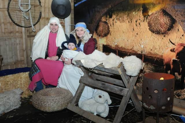 Joseph and Mary with baby Jesus, played by Matthew and Becky Anderson along with baby Alice, at a Living Nativity in Selkirk.