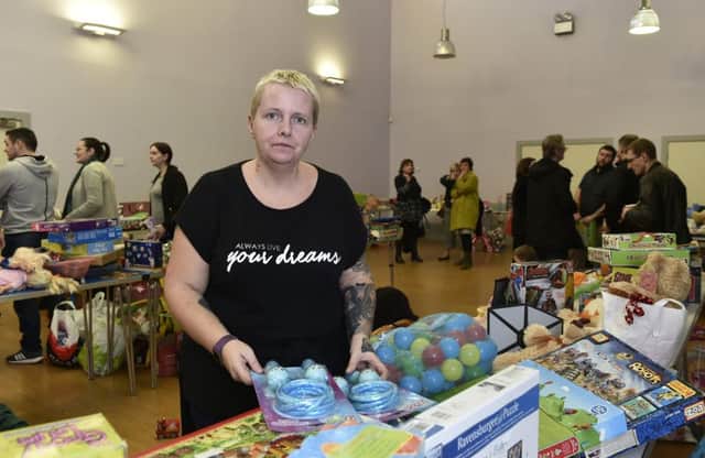 Debbie Harkness helps at a community centre handling donated gifts for the Kaiam staff