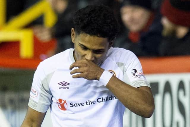 Demetri Mitchell looks dejected for Hearts after being sent off