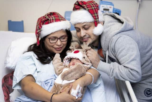Sana (left) and Furquan Ahmad, from Dalkeith, Midlothian, with their baby daughter Efah who was born on Christmas Day morning at 1.09am weighing 6ib 10oz at Edinburgh Royal Infirmary. Picture: Jane Barlow/PA Wire