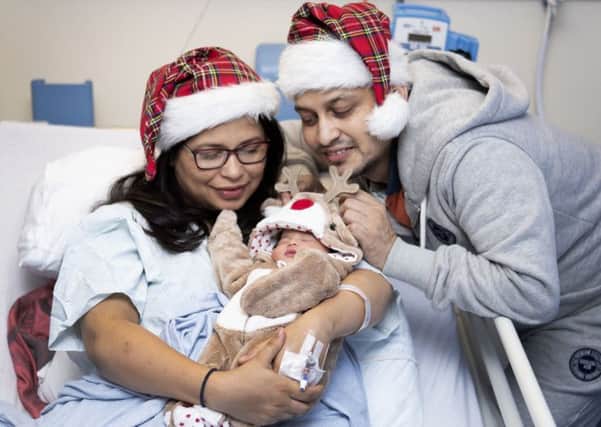 Sana (left) and Furquan Ahmad, from Dalkeith, Midlothian, with their baby daughter Efah who was born on Christmas Day morning at 1.09am weighing 6ib 10oz at Edinburgh Royal Infirmary. Picture: Jane Barlow/PA Wire