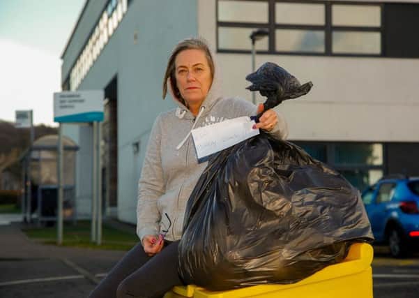 Alison Weir with the rubbish she took to the council HQ. Picture: Scott Louden