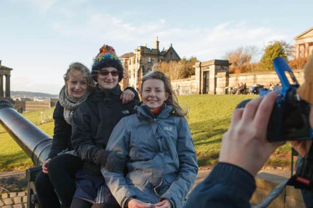 Tourists enjoy the view from Calton Hill, Edinburgh, which will be closed to the public at New Year. Pic: Toby Williams