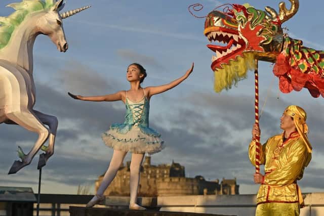 On the rooftop of the National Museum of Scotland, a mythical unicorn lantern lights up the early morning sky alongside a Chinese dragon to mark the launch of the Chinese New Year Edinburgh festival.