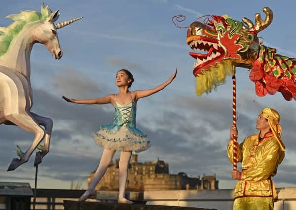 On the rooftop of the National Museum of Scotland, a mythical unicorn lantern lights up the early morning sky alongside a Chinese dragon to mark the launch of the Chinese New Year Edinburgh festival.