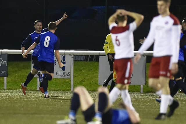 Thomas Orr celebrates his late winner, much to the dismay of the Spartans players at Ainslie Park. Picture: Neil Hanna