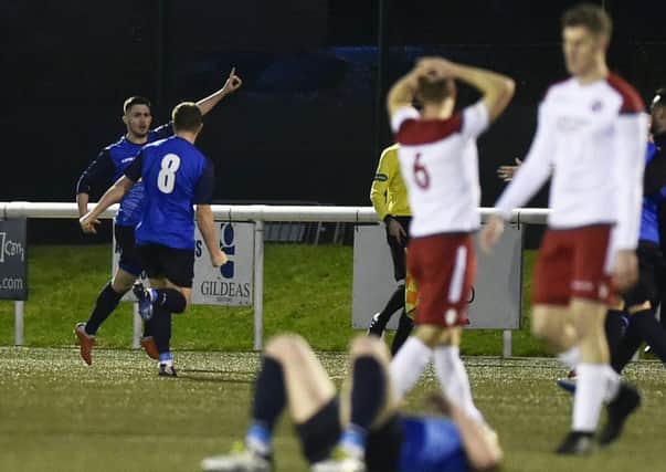 Thomas Orr celebrates his late winner, much to the dismay of the Spartans players at Ainslie Park. Picture: Neil Hanna