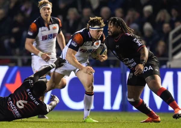 Edinburgh's Hamish Watson breaks through a tackle as  Mathieu Bastareaud closes in. Picture: Christophe SIMON / AFP)CHRISTOPHE SIMON/AFP/Getty Images