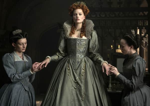 Grace Molony as Dorothy Stafford, Margot Robbie as Queen Elizabeth I and Georgia Burnell as Kate Carey in a scene from "Mary Queen of Scots." (Parisa Tag/Focus Features via AP)