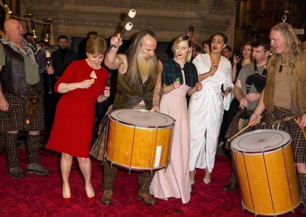 First Minister Nicola Sturgeon and Saoirse Ronan dance with the band as they attend the Scotland premiere of Mary Queen of Scots. Picture: Getty Images
