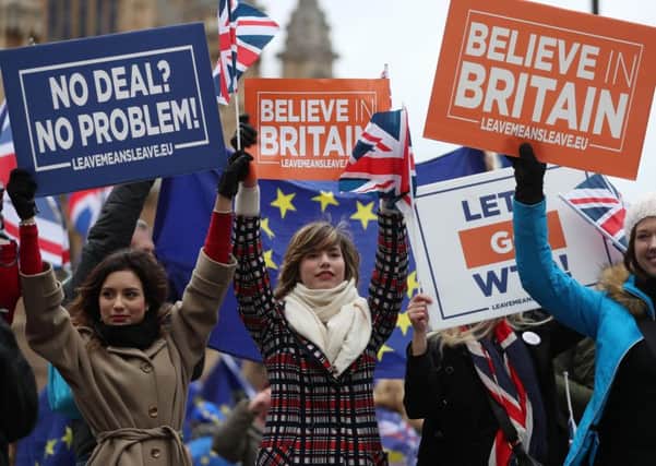 Pro-Brexit supporters hold up placards outside parliament on the day of the 'meaningful vote'. Picture: AFP/Getty