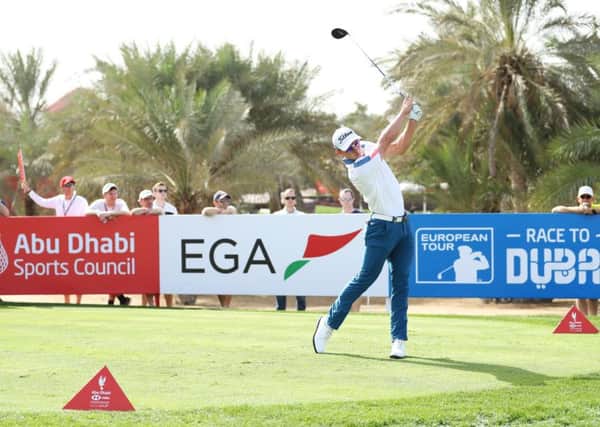 Grant Forrest of Scotland plays his shot from the ninth tee during his third round at the Abu Dhabi Golf Club