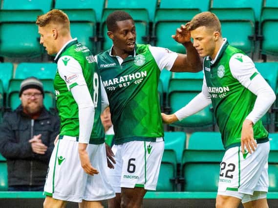 Flo Kamberi is congratulated by team-mates Marvin Bartley and Vykintas Slivka after scoring the opening goal for Hibs against Elgin City