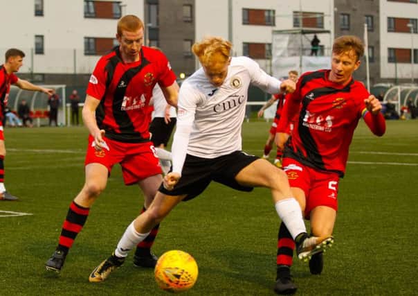 Scott Shepherd of Edinburgh City is surrounded by Annan Athletic players