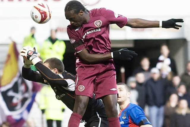 David Obua heads the ball past keeper Ryan Esson to score his first goal for Hearts