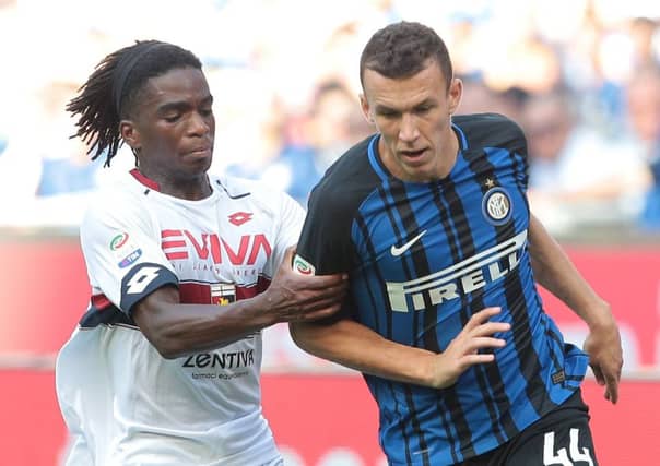 Stephane Omeonga (right) gets to grips with Internazionale's Croatian international Ivan Perisic. Picture: Getty Images