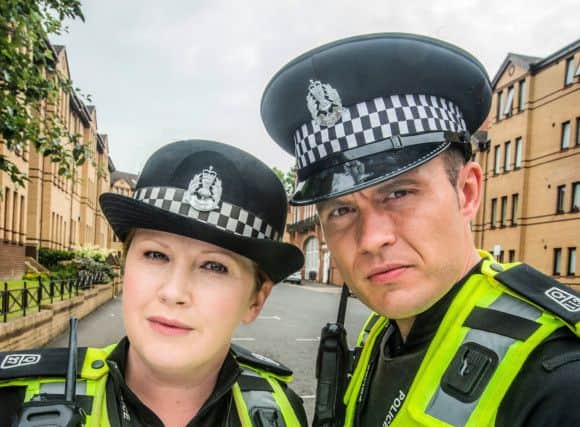 Programme Name: Scot Squad. PC Sarah Fletcher (SALLY REID), PC Jack McLaren (JORDAN YOUNG). Pic: Alan Peebles