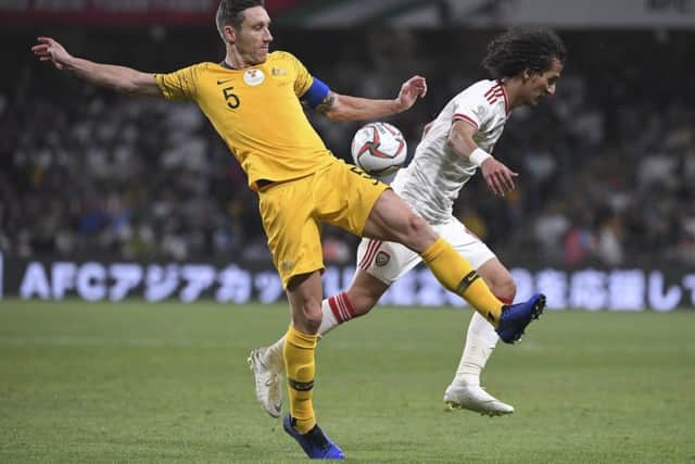 Hibs midfielder Mark Milligan, left, vies for the ball with vies for the ball with United Arab Emirates' midfielder Mohammed Abdulrah. Picture: AP Photo/Hassan Ammar