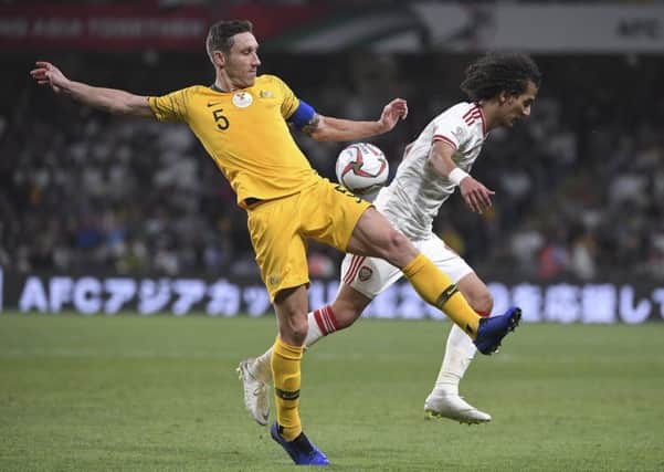 Hibs midfielder Mark Milligan, left, vies for the ball with vies for the ball with United Arab Emirates' midfielder Mohammed Abdulrah. Picture: AP Photo/Hassan Ammar