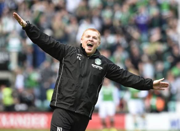 Hibernian manager Neil Lennon celebrates in front of the Rangers fans after his team scored a late equalising goal at Easter Road