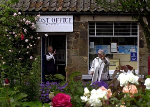 May Fairbairn waves goodbye to a customer during her days running the Drem Post Office. Picture: Neil Hanna