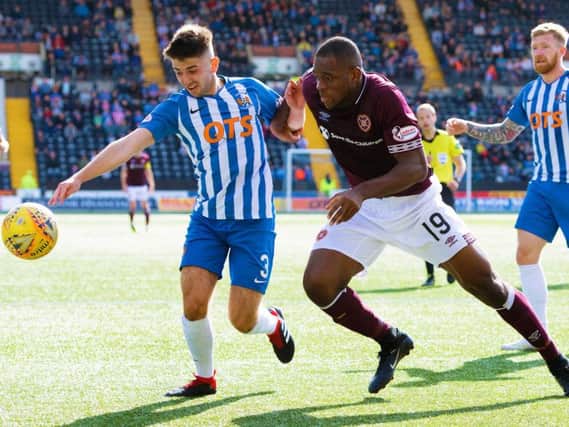 Uche Ikpeazu challenges Greg Taylor in the last meeting between the two sides at Rugby Park, which Hearts won 1-0.