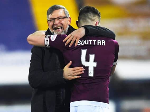 Craig Levein and John Souttar celebrate Hearts fifth win in six matches.