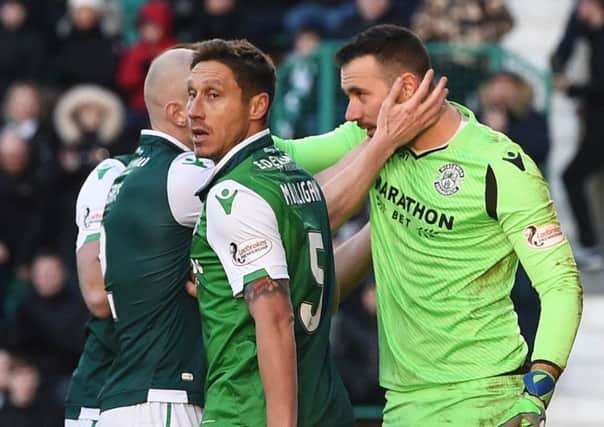 Hibs players congratulate Ofir Marciano for his penalty save