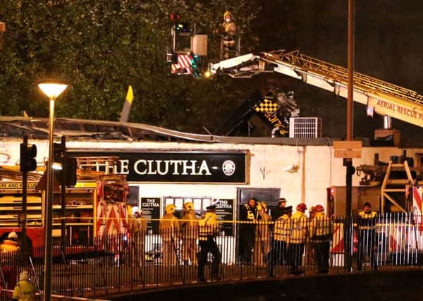 Police and Scottish Fire and Rescue services at the scene of a helicopter crash at the Clutha Bar in Glasgow. Pic: Andrew Milligan/PA Wire