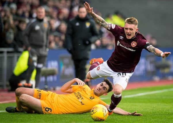 Hearts' Callumn Morrison skips past Livingston's Shaun Byrne in their meeting last month. Pic: SNS