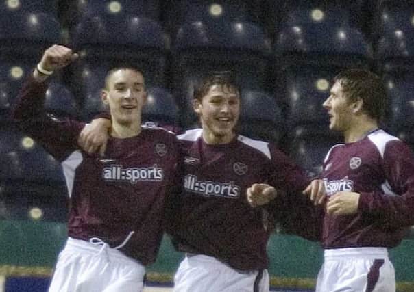 Lee Wallace, left, celebrates his debut goal for Hearts with Saulius Mikoliunas, centre, and Dennis Wyness