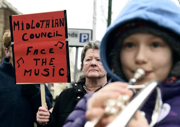 A young trumpeter joins the protest outside the council chambers in Dalkeith. Picture: Lisa Ferguson