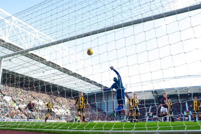 Christophe Berra's header soars over the Auchinleck goalkeeper Andrew Leishman to put Hearts 1-0 ahead