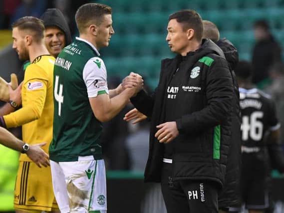 Paul Heckingbottom speaks with Paul Hanlon after Hibs recorded a 2-0 win over Hamilton