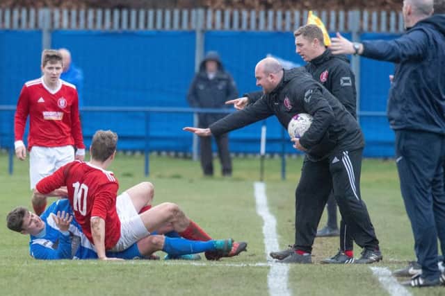 Penicuiks Steven Notman and Hill of Beaths Daniel Watt clash.