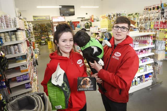 Craig Davidson and Livvie Innes of Dofos Pet Store on Leith Walk with their dog, Royston.  Pic: Greg Macvean