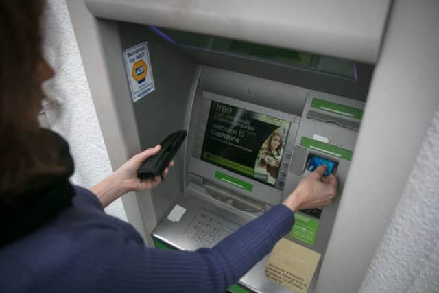 A woman using an ATM. Pic: Matt Cardy/Getty Images