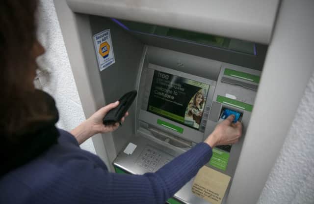 A woman using an ATM. Pic: Matt Cardy/Getty Images